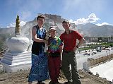 Tibet Lhasa 03 03 Charlotte Ryan, Dangles, Peter Ryan, Jerome Ryan At South West Corner Of Potala Palace Charlotte Ryan, Dangles, Peter Ryan, and Jerome Ryan pose just up the hill opposite the south-west corner of the Potala, with once again juniper smoke going up to the heavens. There was a Chinese soldier there to make sure there wasn't too much smoke to hide the view of the security camera. To the lower right, across from the Potala they are redoing the large Chinese-style open square in a more Tibetan motif, once again to celebrate the 40th anniversary of the Tibet Autonomous Region.